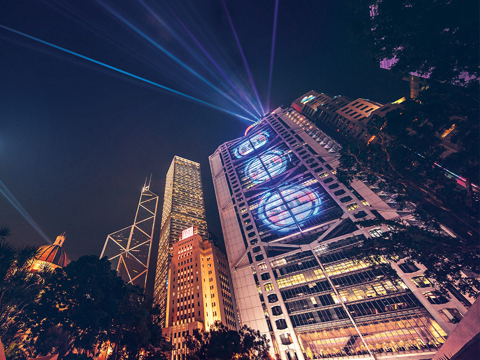 Low angle of HSBC and Bank of China Buildings at night.