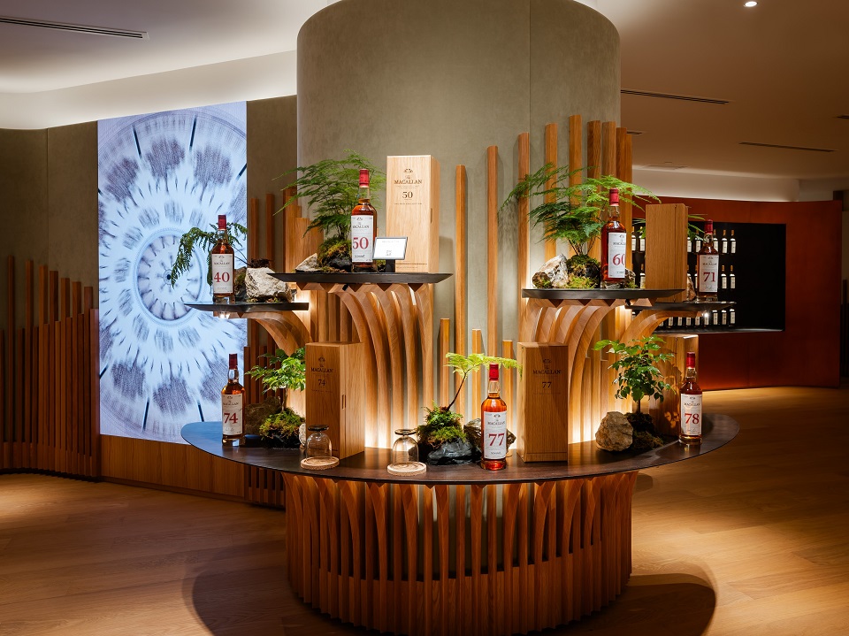 Bottles of whisky on display among green plants at The Macallan House in Hong Kong 