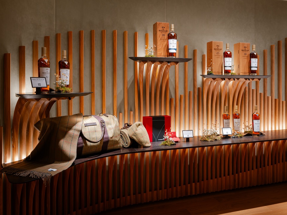 A wall displaying various bottles of whisky at The Macallan House in Hong Kong