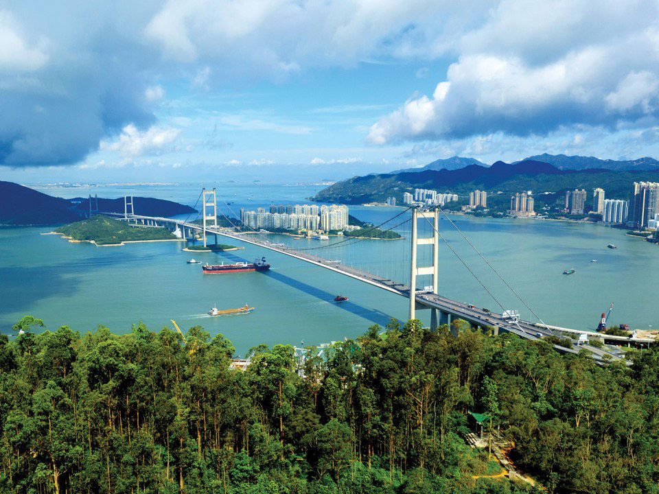 View of Hong Kong stretching across Tsing Yi with sea, mountains and bridges.